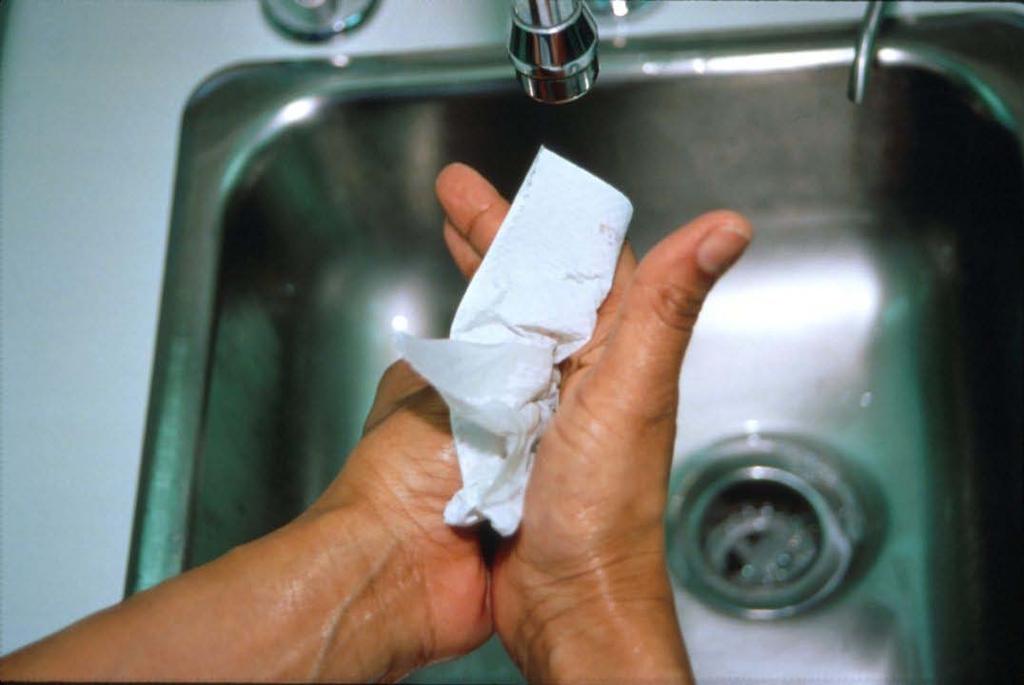 22. Dry your hands and arms completely with a disposable paper towel. Dry in this order: fingers first, then hands and wrists, and finally forearms.