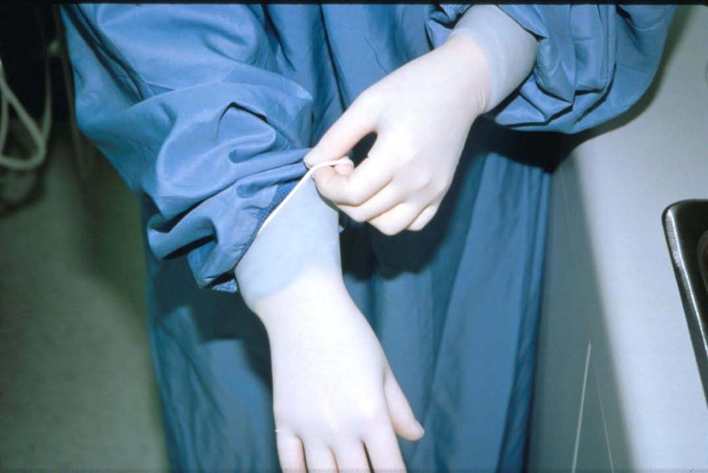 27. Put on patient treatment gloves.