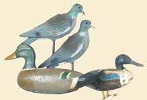 A mallard drake made by Don Contrachris in original paint with wear. Made of very heavy wood. 150-300 294. Lot of three Mason decoys.