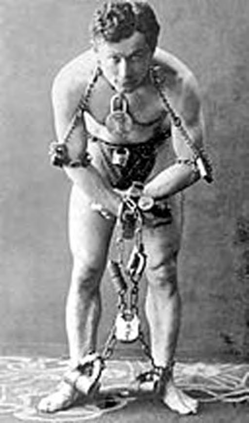 Harry Houdini: Chained to Magic Man Overboard A tugboat floated in New York s East River. It was summer and it was hot outside. The sun beat down on reporters who stood on the tugboat.