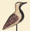 Second is a yellowlegs with head turned to the right and carved, split tail by H.V. Shourds of New Jersey. H.V. Shourds 1999 written under tail.
