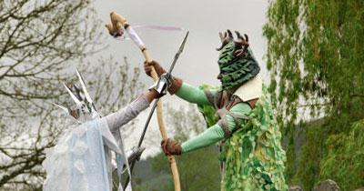 The Green Man battles the Ice Queen on Clun Bridge during Clun's Green Man Festival. A harvest-time tractor travels through Clun with bales of hay.