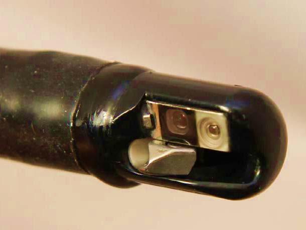 Close-up distal end of a duodenoscope Air/water nozzle Instrument channel exit Elevator (raised position) camer a Light guide Distal cover