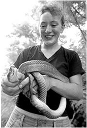 Islands of northern New Guinea. Why is this person smiling while holding a 7 foot long snake?