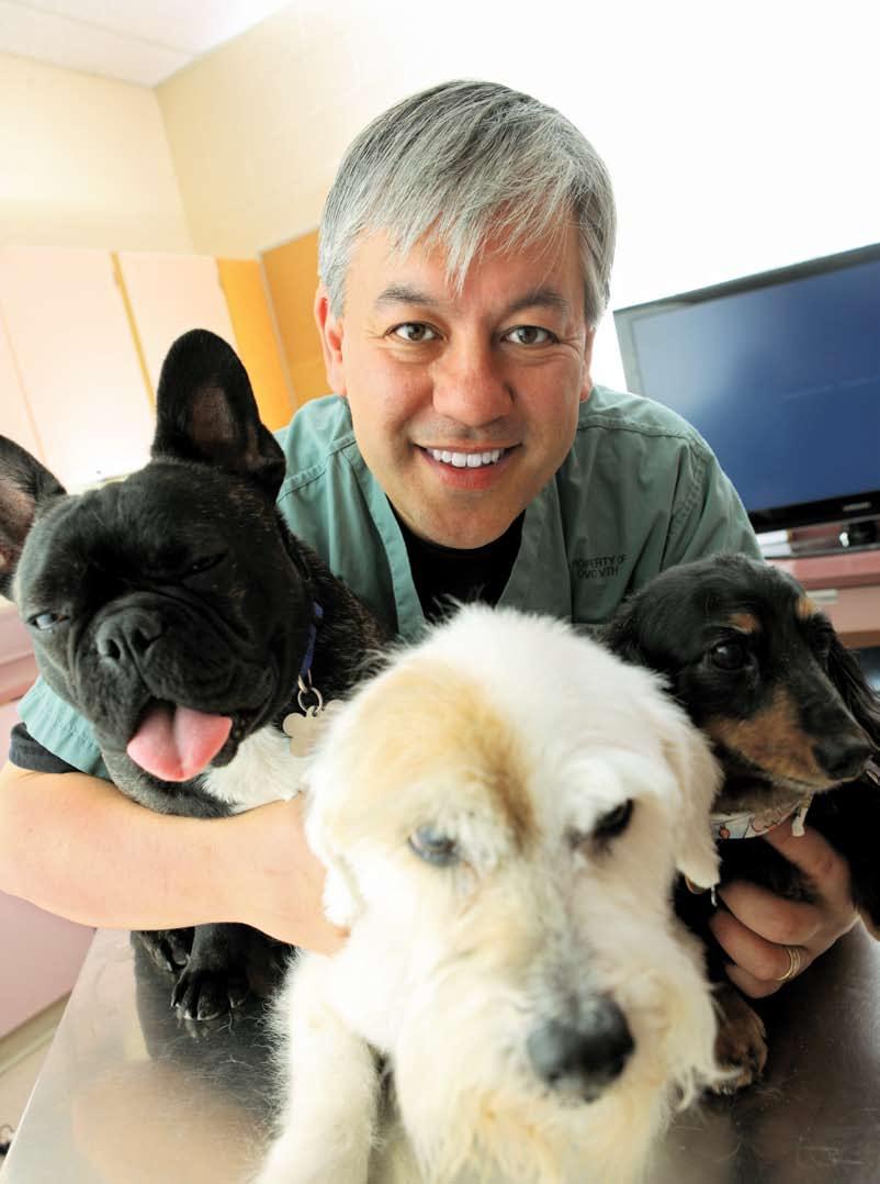Dr. Yu (shown here with his dogs [from left