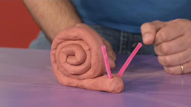Ball of malleable clay Pipe cleaners Roll the ball of clay into a long cylindrical shape by rolling two hands backwards and forwards on the clay.