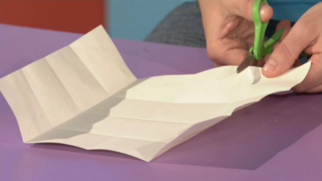 Fold ;paper in-half, then open up so you have a crease down the centre of the paper.