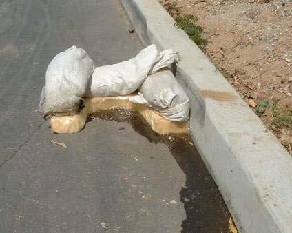 Dam placement at curb Sand bags on styrofoam