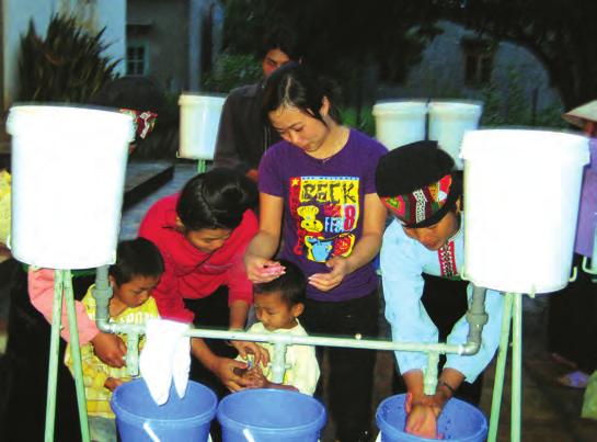 6 Vietnam: A Handwashing Behavior Change Journey Illustration 4: Direct Consumer Contact Event Participants at a Direct Consumer Contact wash their hands before entering the event (left); at one