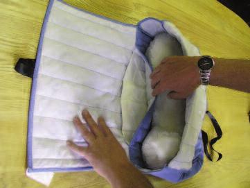 Pet is wrapped in double layer quilted fabric Made of single layer of light blue