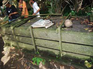 The second home holds a larger 2.5 meter specimen in a wooden crate that is placed out in the middle of a shaded yard next to a chicken coop.