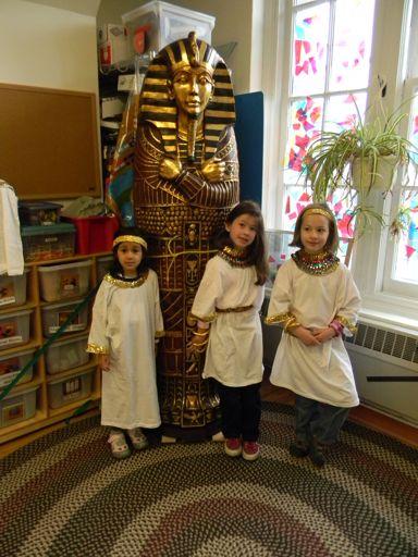 TRAVELING BACK IN TIME Delia, Caroline and Nina C. protect the Pharaoh s sarcophagus.