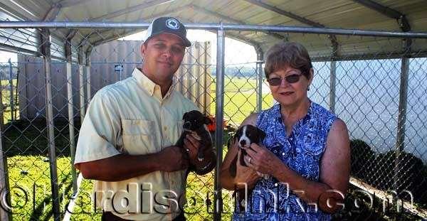 Dogs and cats find new homes County Commissioner Matt Brooks and County Commissioner Lilly Rooks hold two of the five youngest puppies that were fixed and ready for adoption Saturday (Aug. 19).