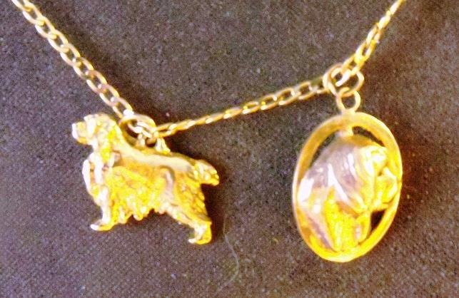 2 small gold plated charms on a chain. The bidding starts at $75.00.