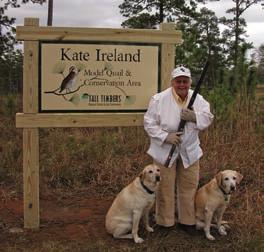 4 Quail Call Winter 27-28 Miss Kate Ireland, Chairman Emeritus of Tall Timbers, stands with her Labrador retrievers, Hebbie and Feisty, at the entrance to the model quail course at the Research