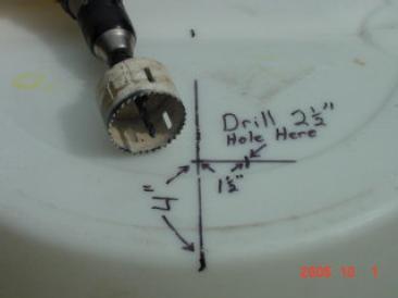 Use a 2-1/2 hole saw to make a hole in the center of the mark you just made.