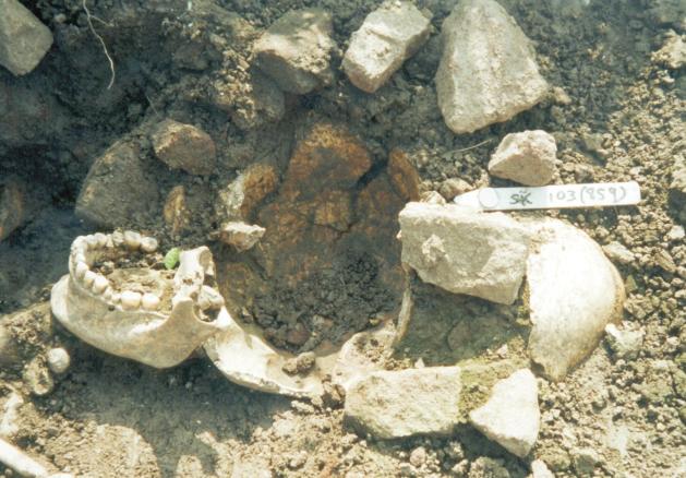 rectangular stone at the back of the head. This burial was undisturbed and there is no doubt that the stones were placed there as part of the inhumation process.