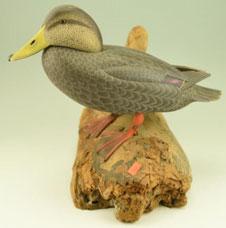 Signed and dated 1967 on driftwood base. Carved raised wing tips in original paint.
