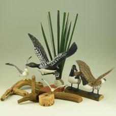 50 (5) Carved miniature decoys on driftwood: Flying
