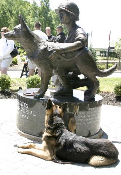 Memorial in Holmdel, New Jersey, consists of a bronze statue of a kneeling Vietnam War soldier and his dog, set on a black granite base.