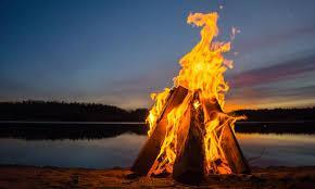 After everyone has eaten to their heart s content, they settle down around the bonfire.