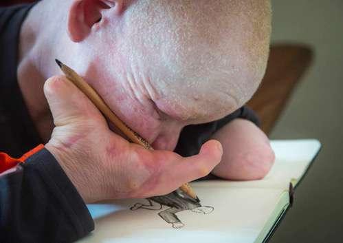Emmanuel Festo, 14, concentrates on his drawing.
