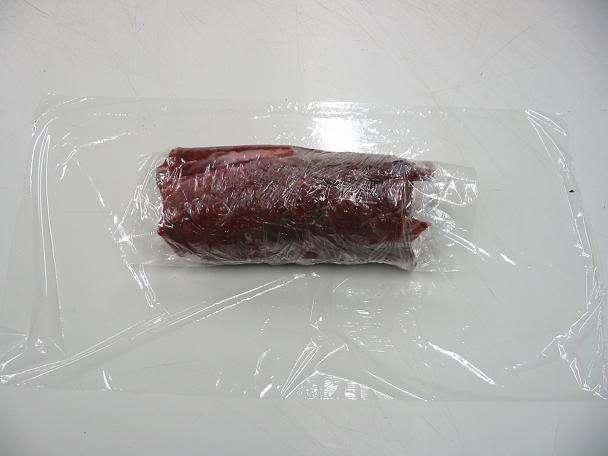 Next, wrap the meat in another layer of plastic wrap but this time, turn the meat and wrap