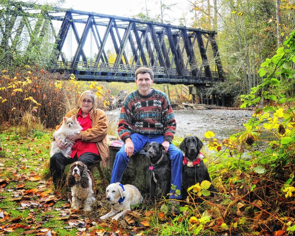 8 Meet Our Members Chris and Claire Cornell with their canine family.