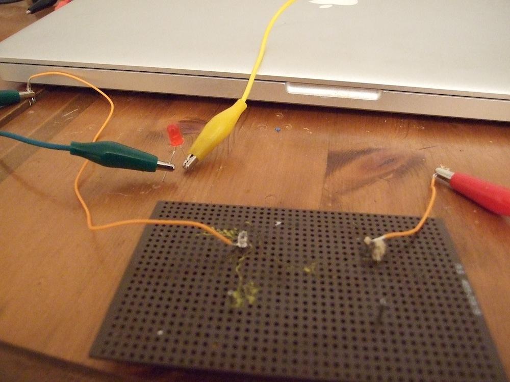 (c) A hybrid circuit including Physarum wire is used to light up a LED.