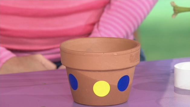 Decorate pot using stickers and/or ribbons.