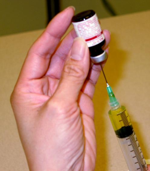 11. With the vial right side up, put the needle straight in. 12. Turn the vial upside down and hold it up in the air. Keep the needle tip in the medicine. 13.