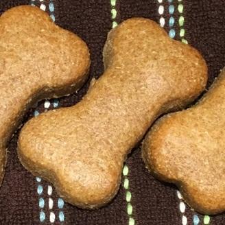 8. Remove cooked cookies from the oven and allow them to cool completely before offering them to your dog.