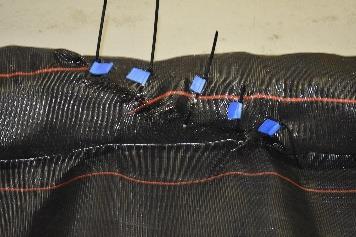 Place Zip Ties or Tie Wire through the holes and tighten to completely cover