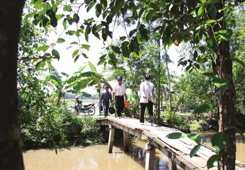 Methodology Enumerators cross a bridge in Tien Giang province for a household interview community, accessibility and connectivity, education and health facilities, water and sanitation related