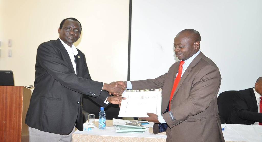 Dr. Juma Ngeiywa, Director of Veterinary Services, Kenya presenting a certificate of participation to Dr. Samuel Lule(Uganda) Dr.