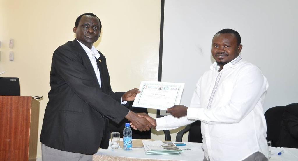 Dr. Juma Ngeiywa, Director of Veterinary Services, Kenya presenting a certificate of participation to Dr.