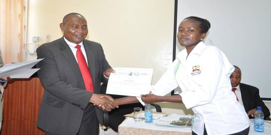 Dr. Anima Sirma being presented with a certificate of facilitation of the workshop