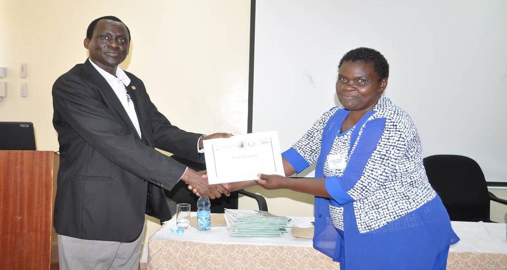 Dr. Juma Ngeiywa, Director of Veterinary Services, Kenya presenting a certificate of participation to Dr. Concepta Nyongesa (Kenya) Dr.
