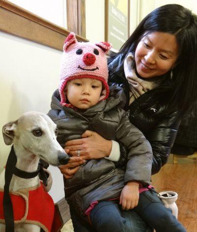 Julie Oh and daughter, Alice, 4, visit with Brasil, a therapy dog,